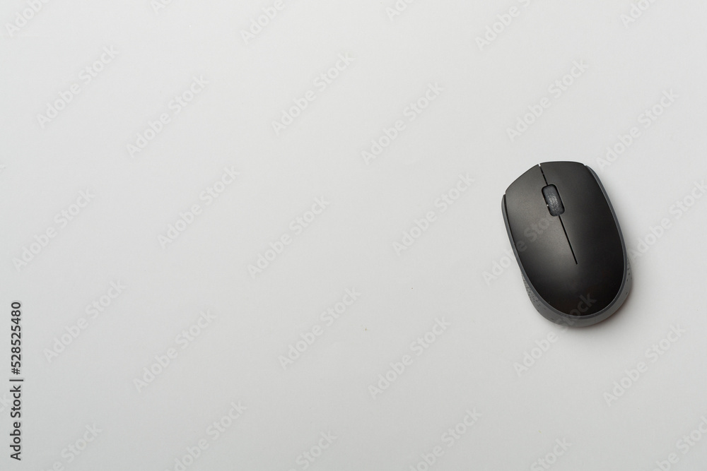 Black wireless mouse on color background, top view Black wireless mouse on color background, top view