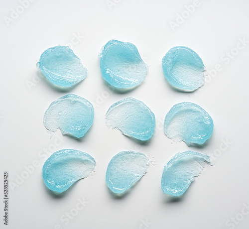 Brushes of light blue gel on a light background.