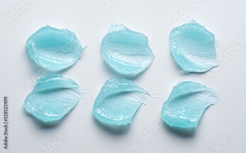 Brushes of light blue gel on a light background.