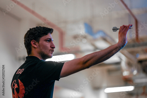 Принти на полотні Darts player from low angle aiming the target