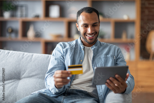 Online Payments. Handsome Black Young Man Using Digital Tablet And Credit Card
