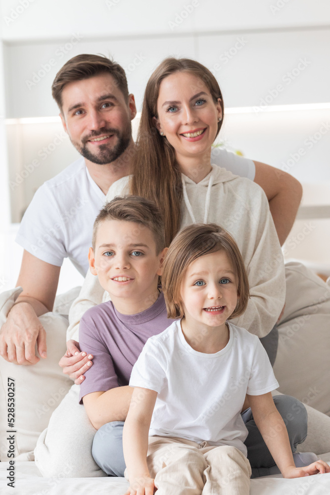 Happy family with children on sofa