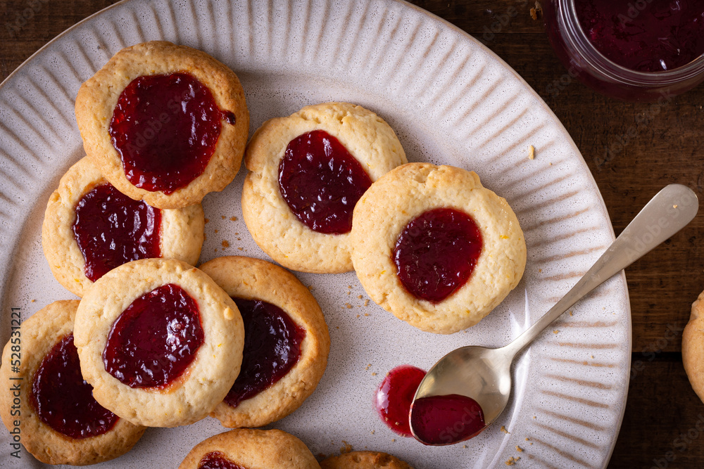 Argentinian traditional cookies called Pepas filled with jam placed on white plate and old wooden table