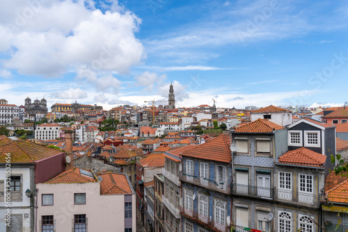 Panoramic view of Porto, seen from the cathedral, with the bell towers of the churches and the colored houses on a sunny day with clouds.
