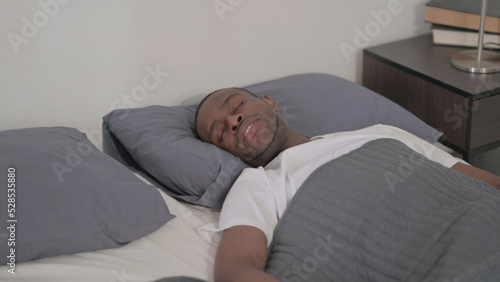 African Man Sleeping in Bed Peacefully