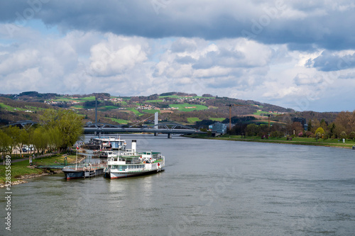 River Danube, boats and bridges between green meadows and forests near the city of Linz. © Denis