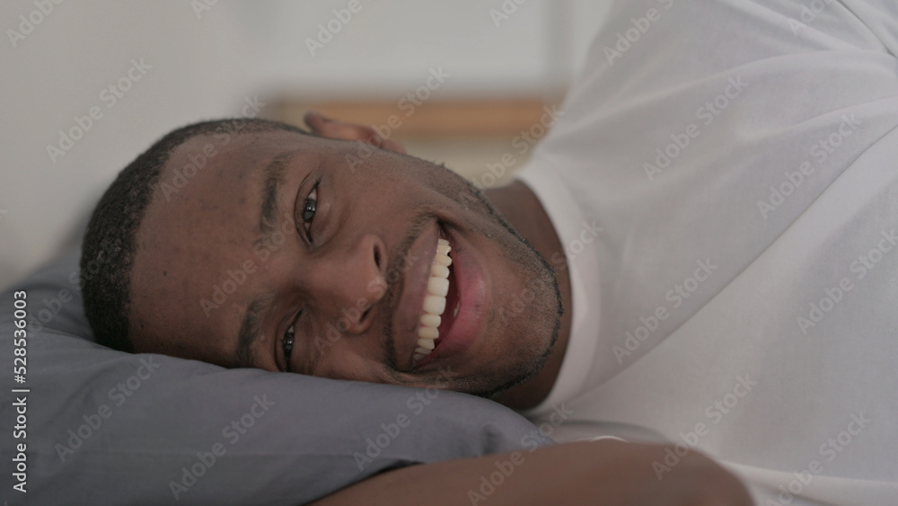 Close up African Man Talking on Video Call while Sleeping in Bed Close up African Man Talking on Video Call while Sleeping in Bed