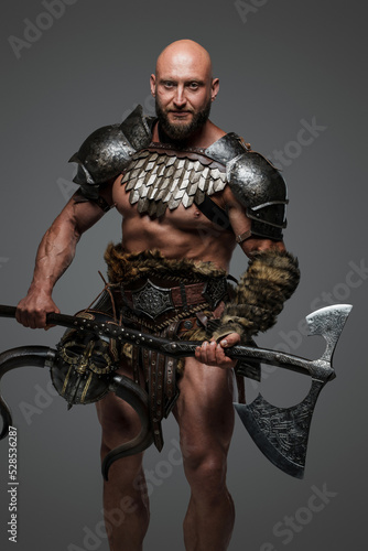 Shot of ancient warrior from north dressed in steel armor holding axe.