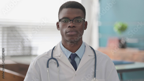 Serious Young African Doctor Looking at the Camera © stockbakers