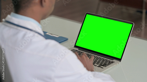 Young African Doctor Using Laptop with Green Screen