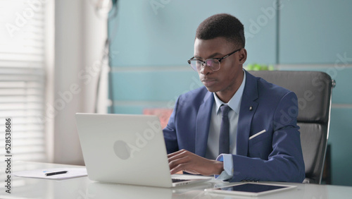 Young African Businessman Working on Laptop in Office