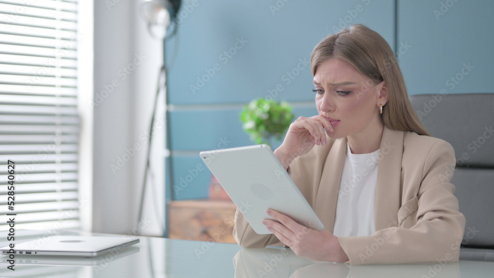 Businesswoman Reacting to Loss on Tablet in Office Businesswoman Reacting to Loss on Tablet in Office