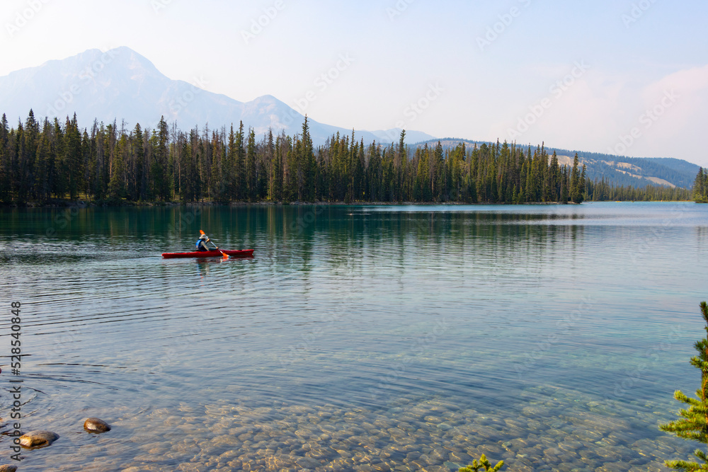 canoe on peaceful lake in canadian rockies