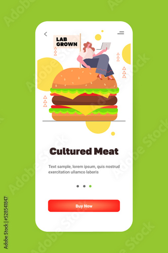 woman with laptop sitting on cultured beef burger made from animal cells artificial lab grown meat production