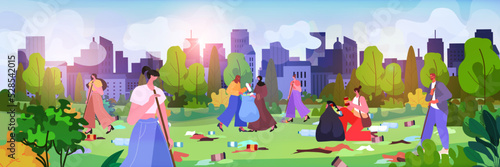 people collecting trash into bags for cleaning urban park clean up garbage ecological challenge save planet world environment