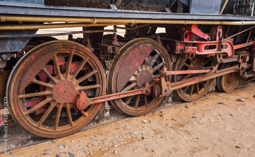 Old unused steam locomotive train at Wadi Rum railroad station, closeup detail to rusty wheels