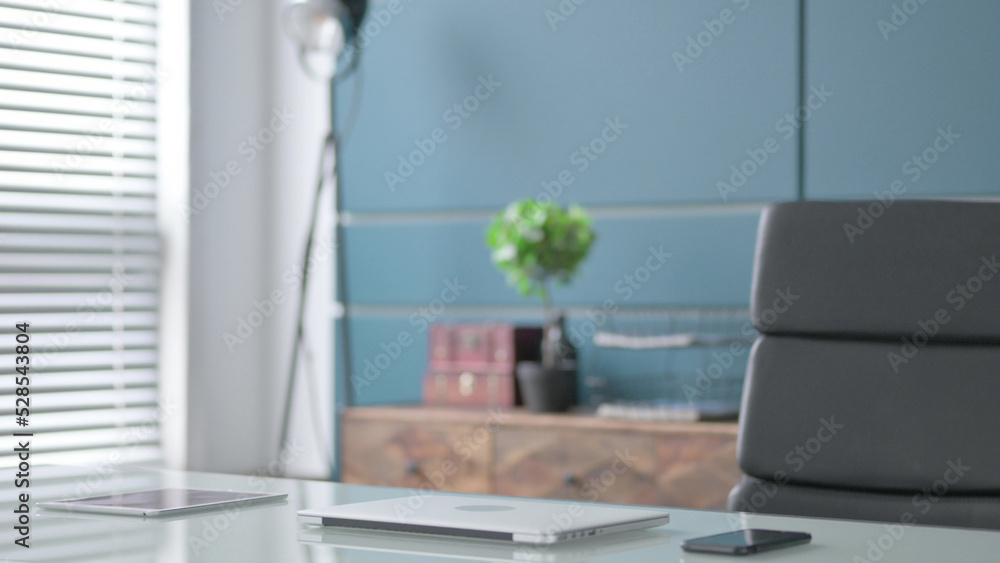 Empty Office with Closed Laptop on Tablet Empty Office with Closed Laptop on Tablet