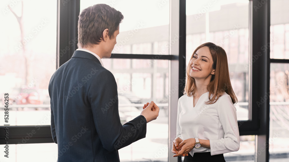 employer gesturing while talking to happy woman on job interview. employer gesturing while talking to happy woman on job interview.