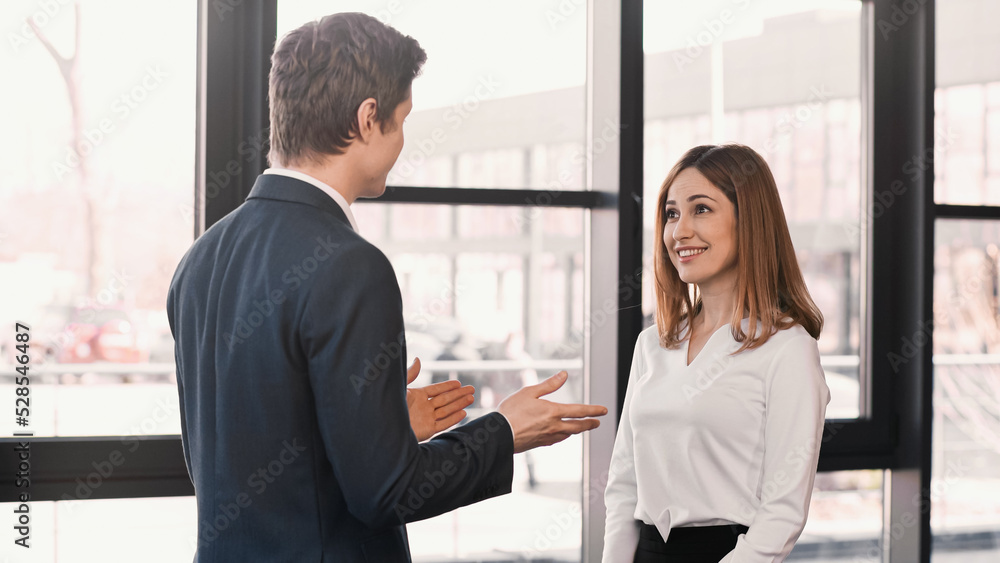 businessman pointing with hands at happy woman during job interview. businessman pointing with hands at happy woman during job interview.