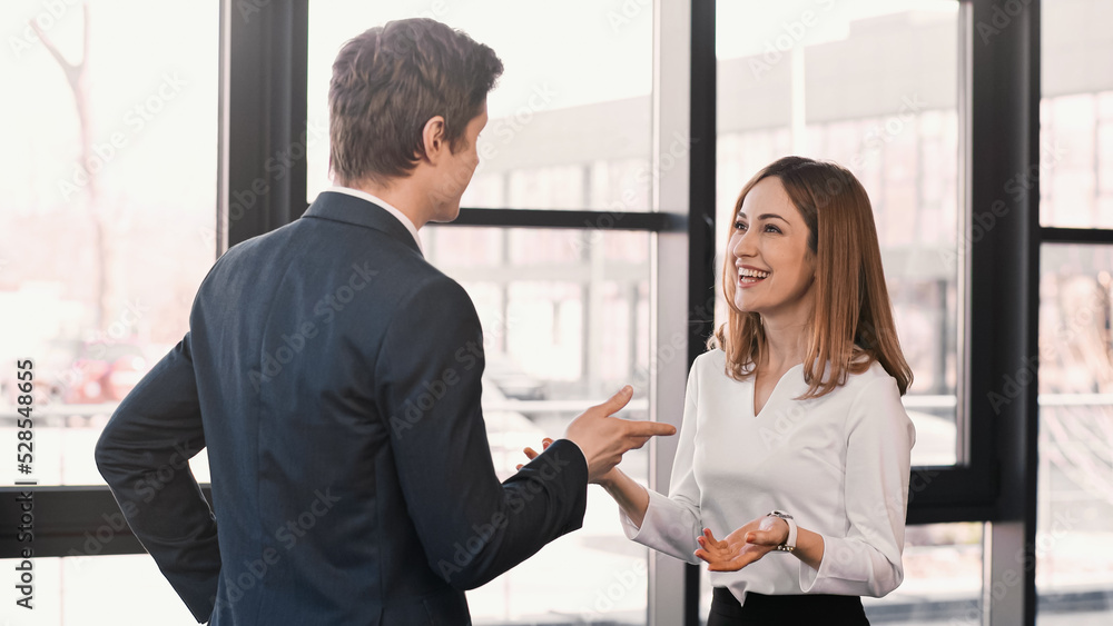 smiling woman and businessman gesturing during job interview. smiling woman and businessman gesturing during job interview.