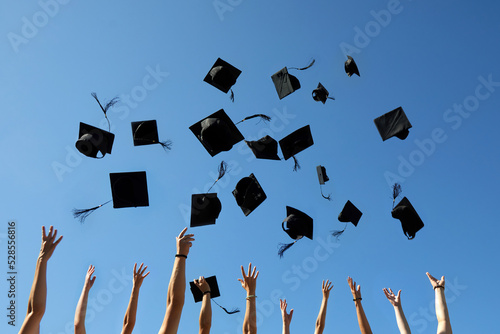 Photography Graduation Caps Thrown in the Air on blue sky