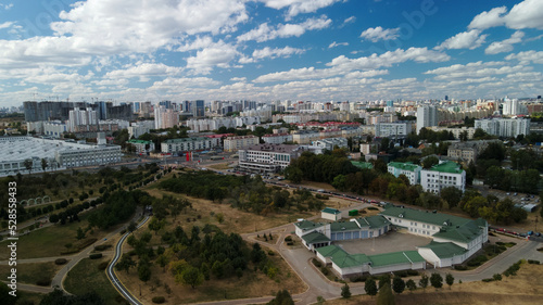 City with high-rise buildings. Park area in the foreground. Blue sky with clouds. Aerial photography. © f2014vad