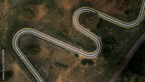 Winding bike path in the city park. City park at dawn. Aerial photography. photo