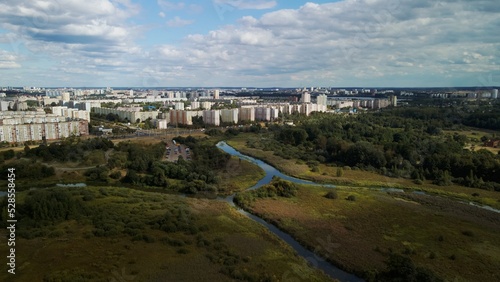 City with high-rise buildings. Park area in the foreground. Blue sky with clouds. Aerial photography.