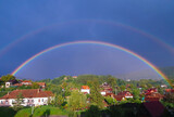 landscape of a semicircle rainbow over the village