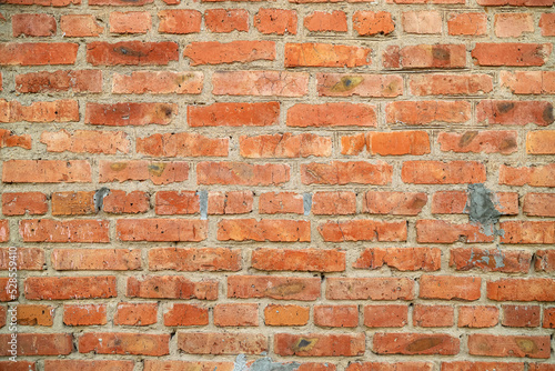 An old damaged brick wall as a background
