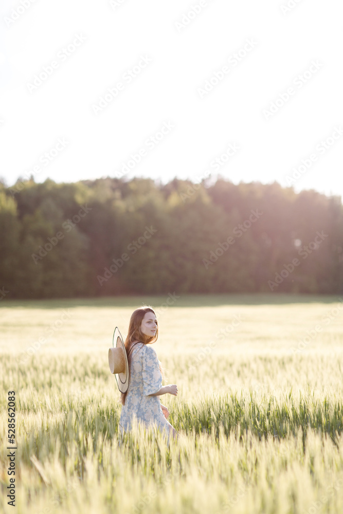 Trendy girl in stylish summer dress feeling free in the field in sunshine. High quality photo Trendy girl in stylish summer dress feeling free in the field in sunshine. High quality photo