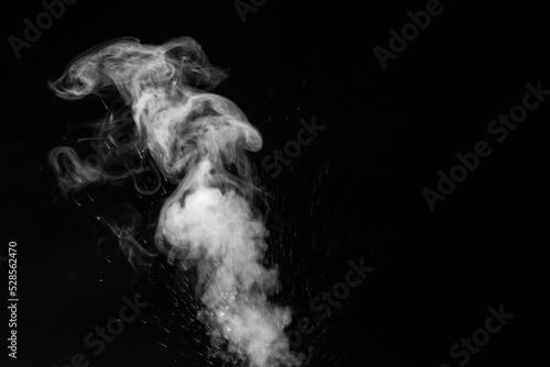 curly white steam and splashing water splashing isolated on black background. Abstract background, design element. Evaporation of liquid and condensation. © Alena