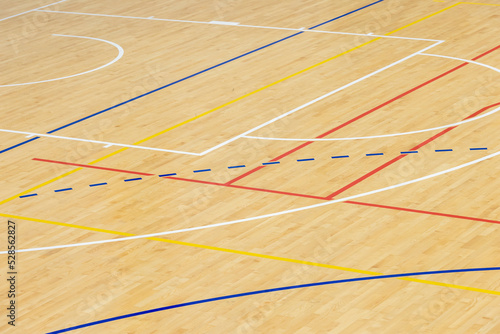 Wooden floor basketball, badminton, futsal, handball, volleyball, football, soccer court. Wooden floor of sports hall with marking lines on wooden floor indoor, gym court