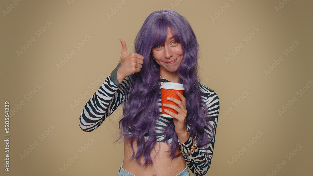 Positive pretty young woman drinking coffee from cup. Adult stylish girl enjoying hot beverage in papercup, holding espresso in hand on beige studio background. Energy and relax with refreshment drink Positive pretty young woman drinking coffee from cup. Adult stylish girl enjoying hot beverage in papercup, holding espresso in hand on beige studio background. Energy and relax with refreshment drink