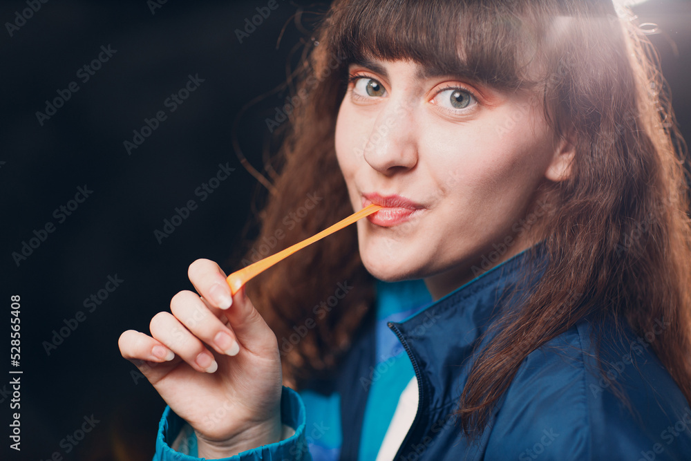 Obraz premium Young sporty woman 80 and 90's style. 90s fashion positive girl with bubble gum