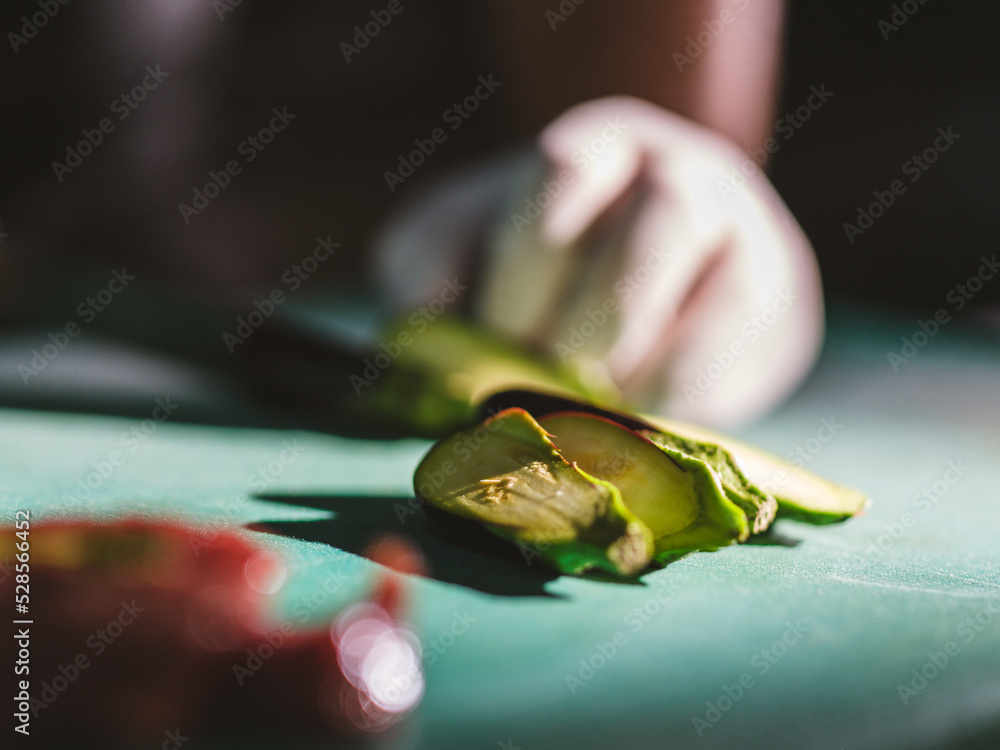 a chef cutting avocados in the kitchen a chef cutting avocados in the kitchen