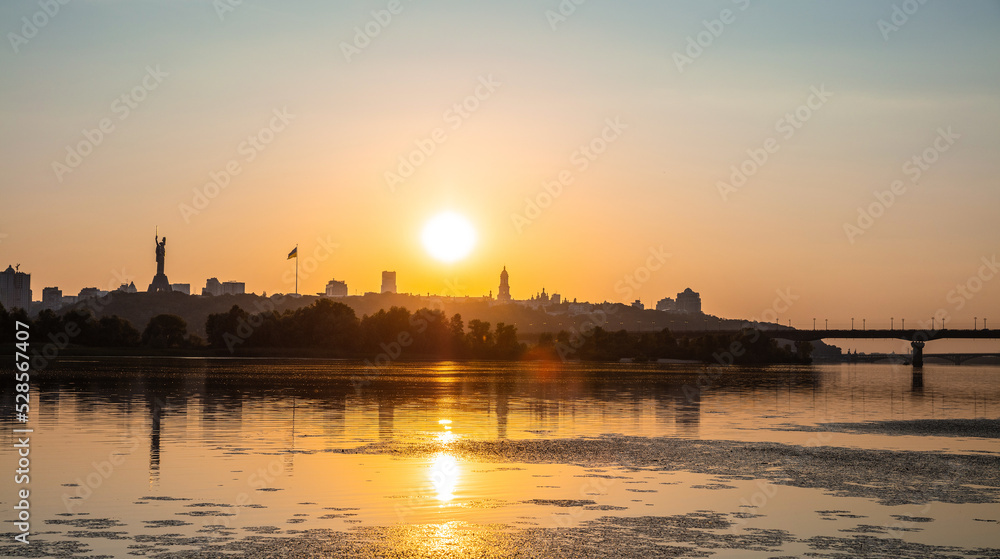 View of Kyiv from left bank of Dnipro river at sunset