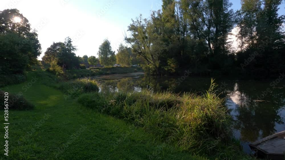 small river with rowing boat in a beautiful landscape small river with rowing boat in a beautiful landscape