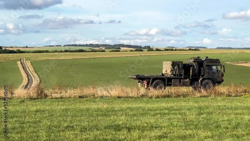 British army MAN HX60 SV 4x4 vehicle carrying a greight pallet on a dirt track in action on a military exercise photo