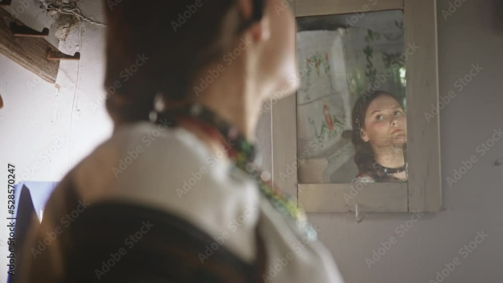 Slavic woman admiring reflection in mirror Slavic woman admiring reflection in mirror
