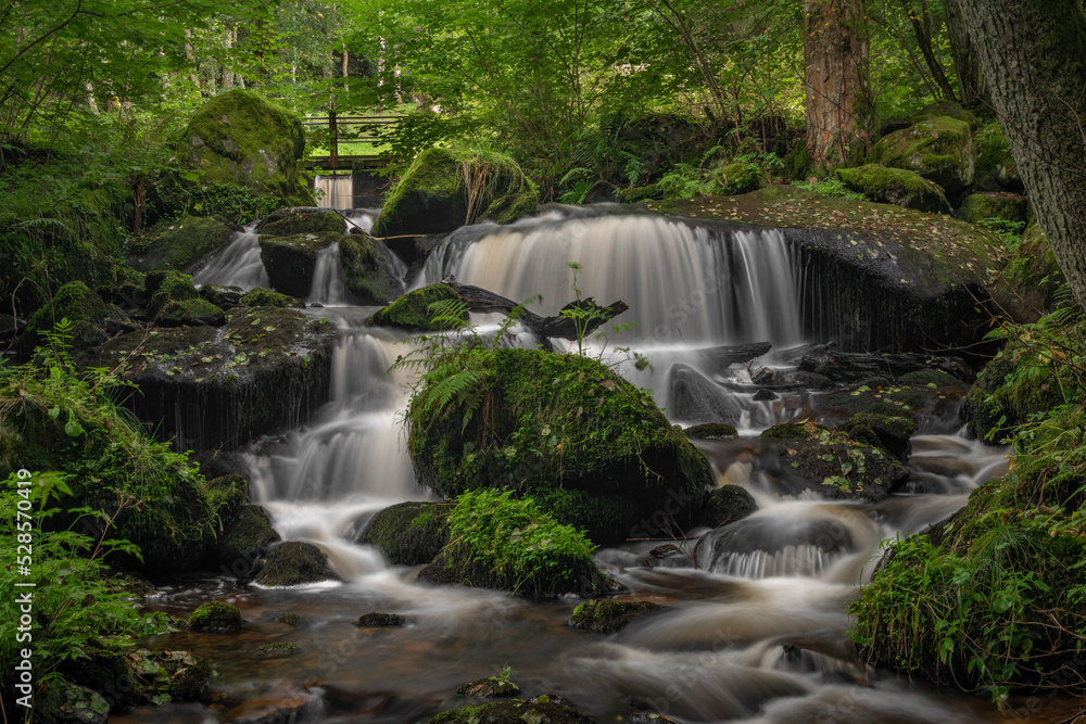 Waterfall under floodgate near Vyssi Brod town in cloudy summer day Waterfall under floodgate near Vyssi Brod town in cloudy summer day