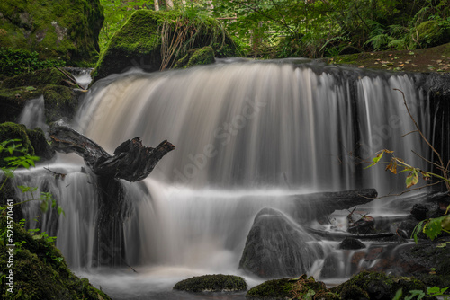 Waterfall under floodgate near Vyssi Brod town in cloudy summer day