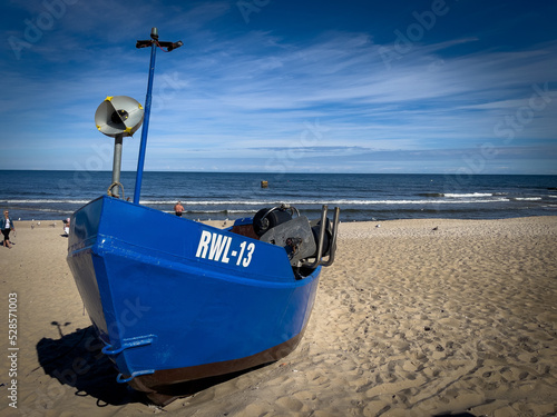 one ishing boat lies on the beach of the polish baltic sea photo
