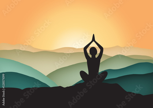 silhouette of a yoga person meditating at sunrise