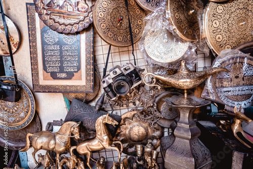 Ancient relics from a street market in Egypt, including a camera, Aladdin's lamp and other gilded objects. photo