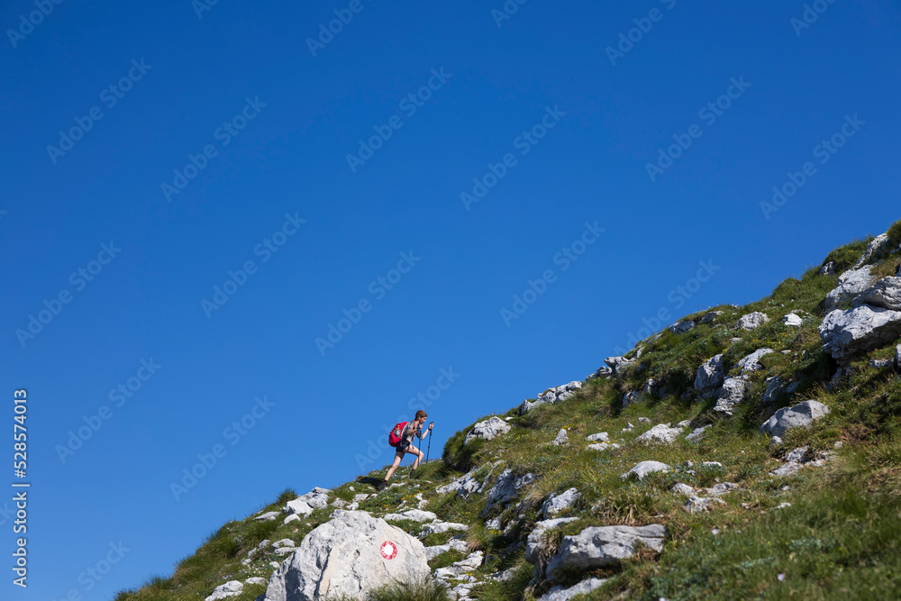 Steep Climb on Top of A Mountain For A Woman Backpacker Tourist