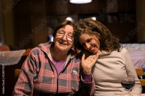 Mother and Adult Daughter Together in Domestic Living Room Enjoying Stay Together