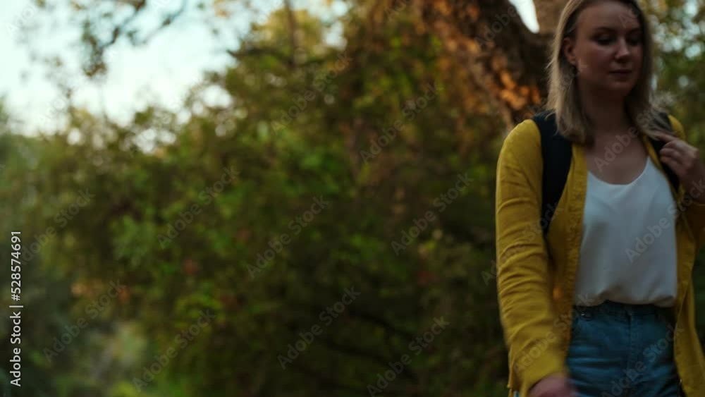 Woman tourist with backpack walking in deep forest. Woman tourist with backpack walking in deep forest.