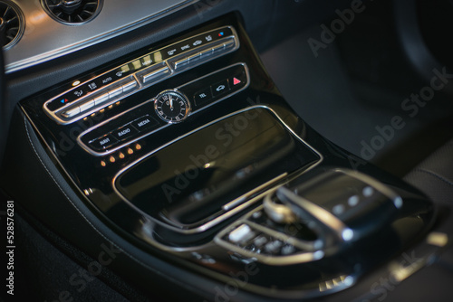 Luxury car interior details. Middle console with air and multimedia controls. 