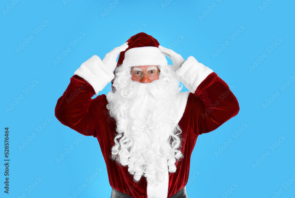 Portrait of emotional Santa Claus on light blue background Portrait of emotional Santa Claus on light blue background